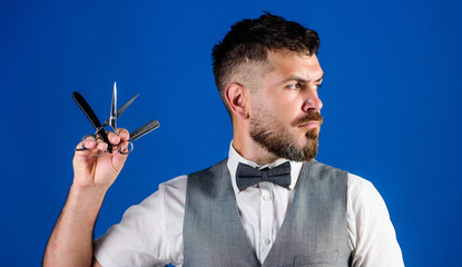 Barbershop hairdresser salon. Barber beard grooming tips. Man vest with bow tie hold straight razor...