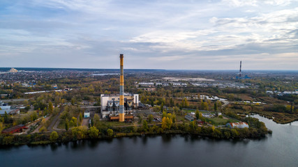 Obraz premium Garbage incineration plant. Waste incinerator plant with smoking smokestack. The problem of environmental pollution by factories.