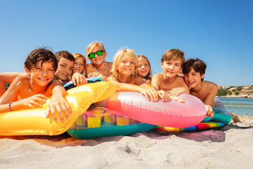 Happy kids spending summer vacation on the beach