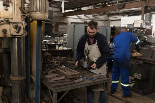 Blacksmith working in workshop