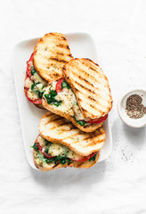 Grilled tomatoes, spinach and mozzarella sandwiches - healthy breakfast, snack, tapas, appetizers...