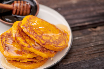 pancake with honey on wooden background