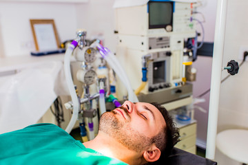 Fototapeta premium Young man lies on the operating table
