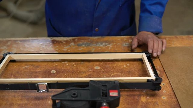 Assembling the wooden frame on the carpentry table in the workshop