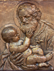 PRAGUE, CZECH REPUBLIC - OCTOBER 13, 2018: The bronze relief of St. Joseph in church kostel Svatého Václava by Emanuel Kodet (1914). © Renáta Sedmáková