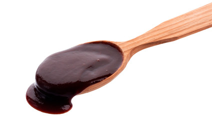 Barbecue sauce with wooden spoon isolated on white background
