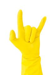 Hand in yellow rubber glove on white background showing gesture sign of the horns, metal horns, devil horns, rock horn. Isolated glove for cleaning on white background.
