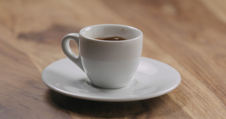 cup of fresh espresso on wood table