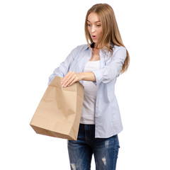 Woman holding a paper bag package shopping beauty on a white background. Isolation