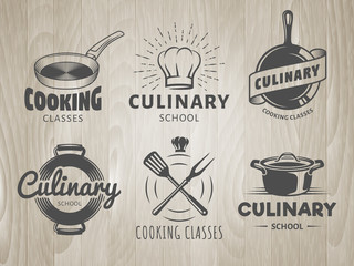 Culinary school logos. Vector labels for cooking classes, workshops and courses. Set of monochrome badges with chefs hat, pans and kitchenware on vintage wooden background