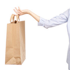 Woman holding a paper bag shopping beauty on a white background. Isolation