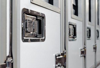 row of identical doors with a handle closeup