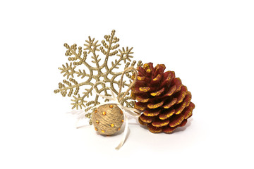 Christmas decoration pine cone with sparkles, shiny snowflake and handmade ball on white...
