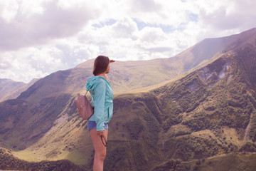 Woman is standing on the high mountain in Kazbegi, Georgia