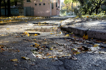 large pit with stones on the asphalt road