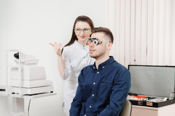 Attractive dark-haired girl doctor ophthalmologist smiles