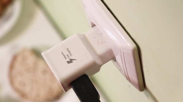 In the frame of the hand puts charging in the outlet. Quick charge.