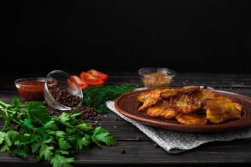 Exquisite Ukrainian cuisine in detail: fried potatoes with a golden crust combined with fragrant spices and fresh herbs.