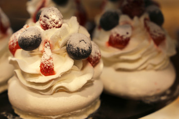 Meringue cake with blueberries, strawberries and raspberries