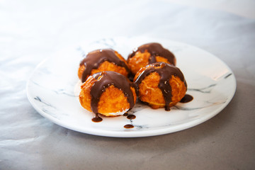 Profiterole with vanilla and chocolate sauce