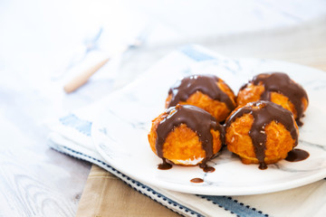 Profiterole with vanilla and chocolate sauce