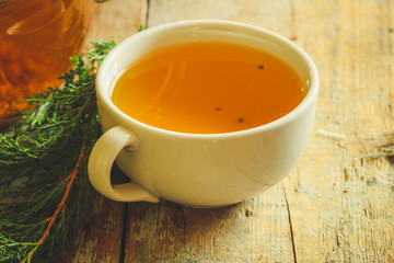 tea in a transparent teapot on the table (herbal tea is brewed). top view.