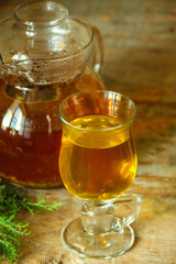 tea in a transparent teapot on the table (herbal tea is brewed). top view.