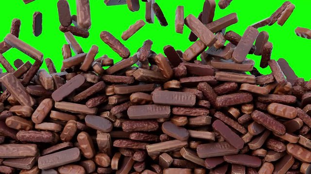 Mix of chocolates falling down from above and filling the screen. Sweets brown background pattern texture on green screen.