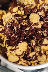 Chocolate covered cornflake cluster cookies, an easy and fun holiday or Christmas cooking project with kids, no-bake recipe for tiny cakes or semi-sweet cocoa snacks