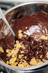 Chocolate covered cornflake cluster cookies, an easy and fun holiday or Christmas cooking project with kids, no-bake recipe for tiny cakes or semi-sweet cocoa snacks