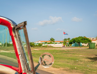Cuba Varadero, view inside an old vintage classic american car on the right Cuban flag,sunny day.