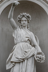 Statue of sensual busty and puffy renaissance era woman in circlet of flowers, Potsdam, Germany,...