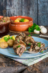 Fototapeta na wymiar Beef roulade staffed with mushrooms in creamy mushroom sauce served with boiled baby potatoes