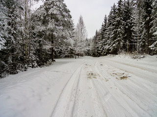 Obraz premium drone image. aerial view of rural area with fields and forests in snowy winter