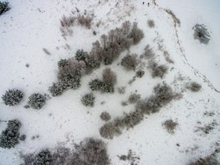 drone image. aerial view of rural area with fields and forests in snowy winter