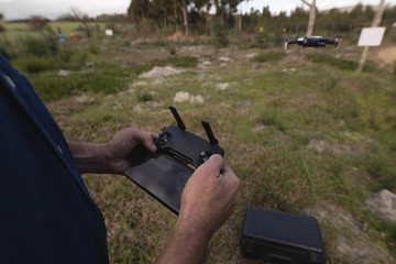 Lumberjack operating drone in forest