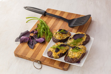Sliced eggplant baked with cheese and grilled cheese  on the kitchen table