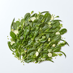Composition of fresh green spinach vegetables, cucumber slices, mint leaves, asparagus and cabbage...