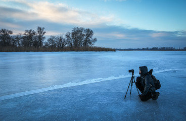Photographer take pictures on the ice in the morning