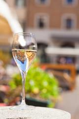 Glass of chilled prosecco on Padova streets background