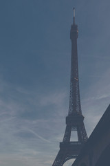 Fototapeta na wymiar Foggy image of the Eiffel Tower - main tower and symbol of Paris, France.