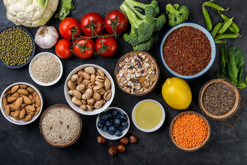 Healthy food,  berries, vegetables, seeds, superfood, cereals on gray background top  view