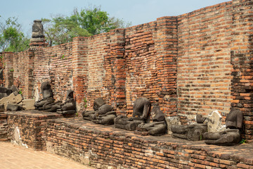 Ruins of Wat Mahathat temple with ancient broken headless Buddha statues in UNESCO heritage of...