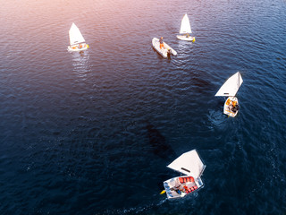 Aerial drone competitions sport white yachts and boats on blue water of sea.