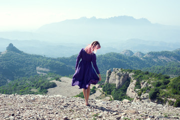 Naklejka premium Woman on top of the mountain. Montserrat, Barcelona, Spain.