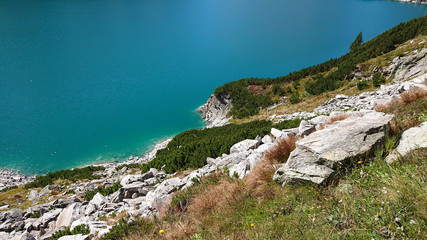 Arch dam (Kölnbreinsperre) in Austria (Kärnten) at 1.890 meters height. Beautiful blue lake with blue skies. Perfect scenery for hiking in the mountains. The lake is called Kölnbreinspeicher.
