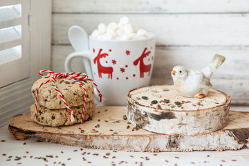 Homemade cookies and cup of cocoa with marshmallow in christmas decoration