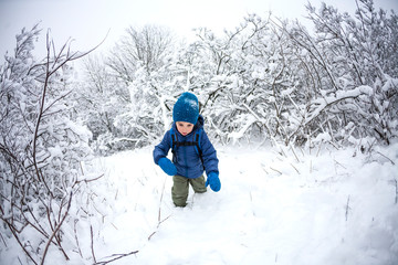 Fototapeta na wymiar A child runs through the snow.