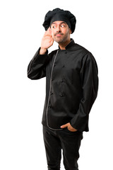 Chef man In black uniform listening to something by putting hand on the ear on isolated white background
