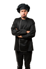 Fototapeta na wymiar Chef man In black uniform with sad and depressed expression. Serious gesture on isolated white background